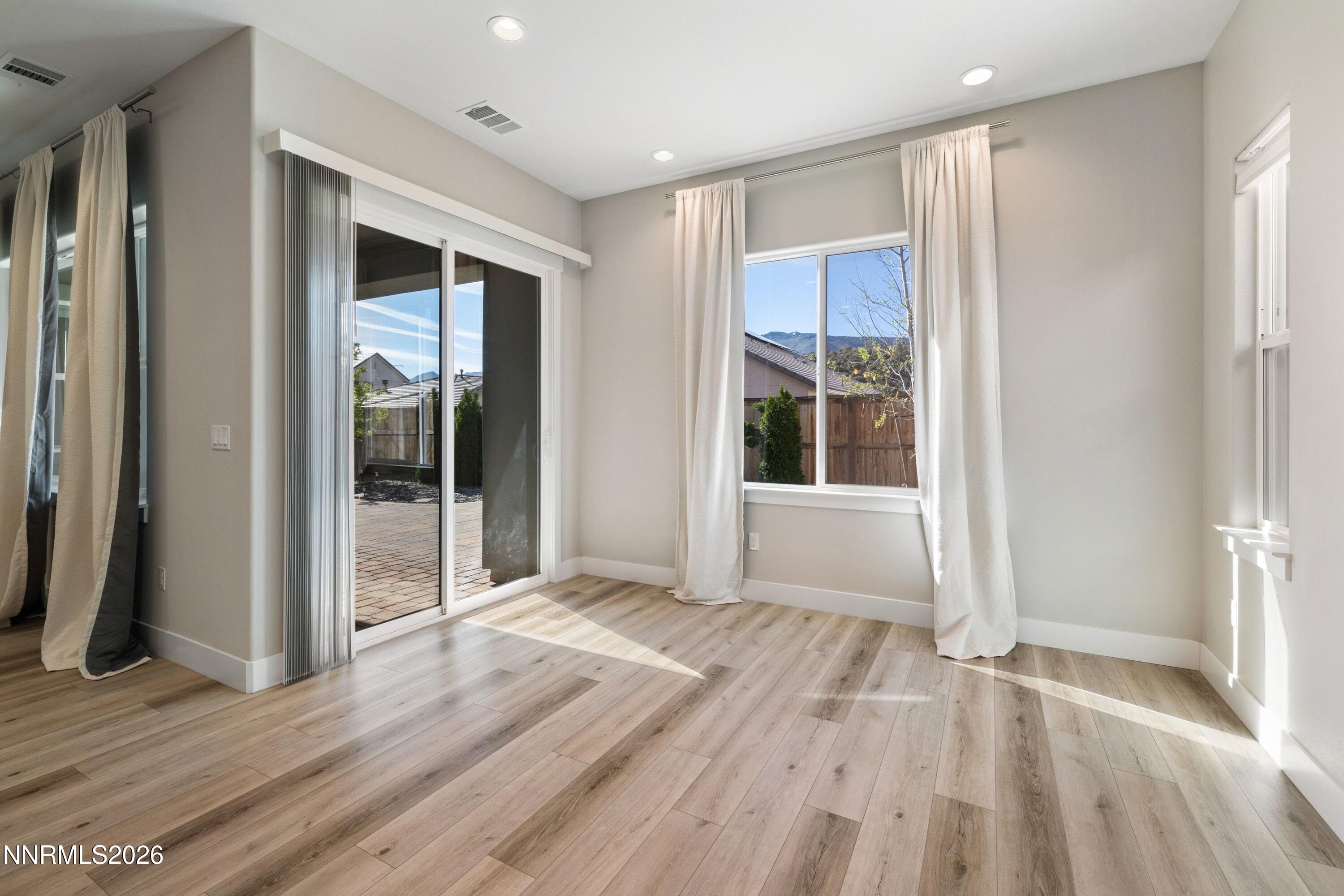 250 Commodore Drive Verdi, NV 89439 - Photo 17 of 49 a view of an empty room with wooden floor and a window