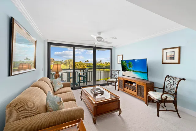 a living room with furniture and a floor to ceiling window