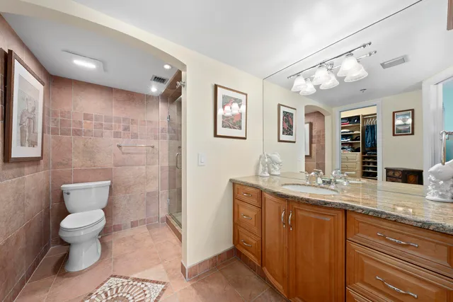 a bedroom with a large bed and a tv on the dresser