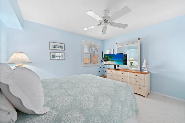 a spacious bathroom with a granite countertop sink toilet and mirror