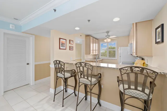 a view of a dining room with furniture and a large window