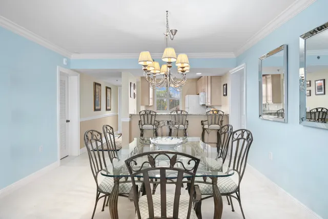 a view of a dining room with furniture and a chandelier