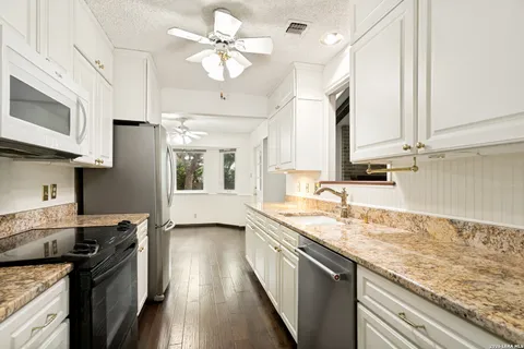 a kitchen with a stove a sink and a microwave