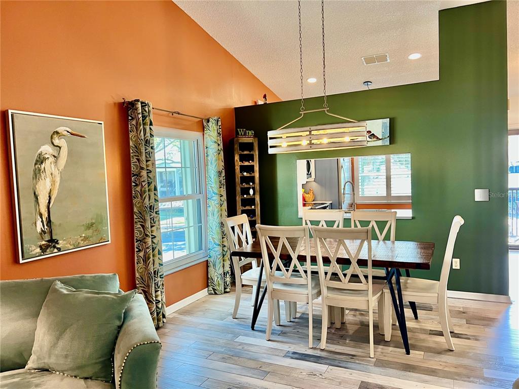 2150 Elm Street, Unit 605 Dunedin, FL 34698 - Photo 15 of 55 a view of a dining room with furniture window and wooden floor