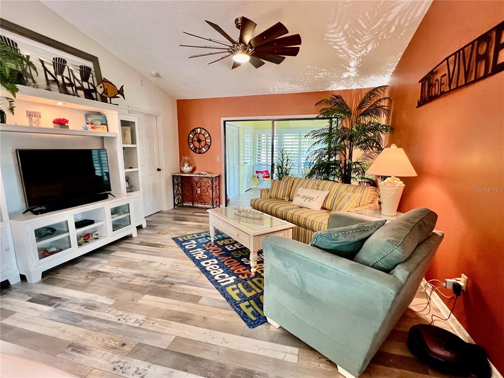 2150 Elm Street, Unit 605 Dunedin, FL 34698 - Photo 19 of 55 a living room with furniture and a flat screen tv