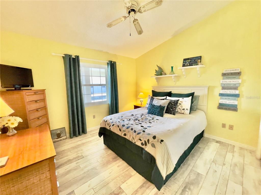 2150 Elm Street, Unit 605 Dunedin, FL 34698 - Photo 31 of 55 a bedroom with a bed and wooden floor