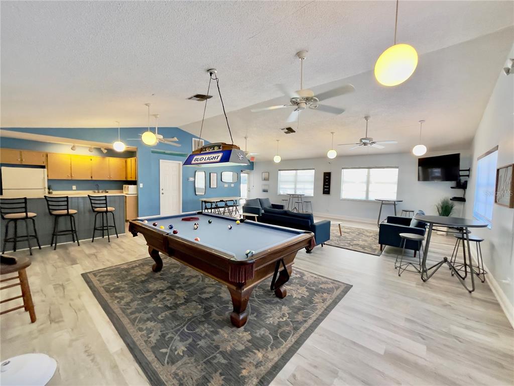 2150 Elm Street, Unit 605 Dunedin, FL 34698 - Photo 50 of 55 a room with lots of furniture and a chandelier