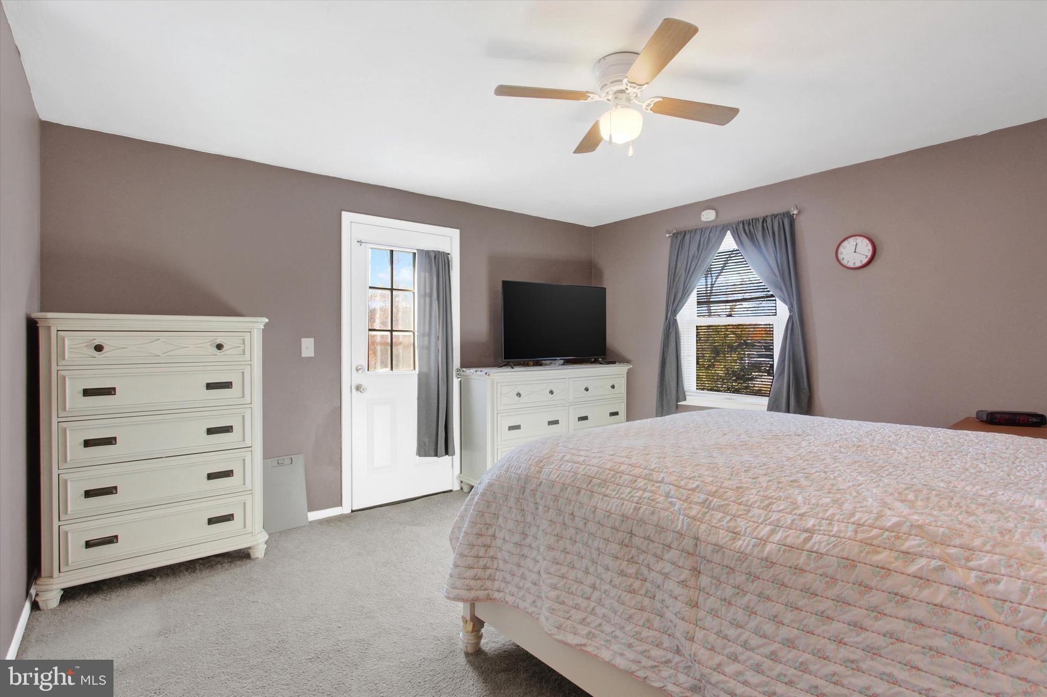 1365 Hanover Road Gettysburg, PA 17325 - Photo 15 of 26 a bedroom with a bed a flat screen tv and a dresser