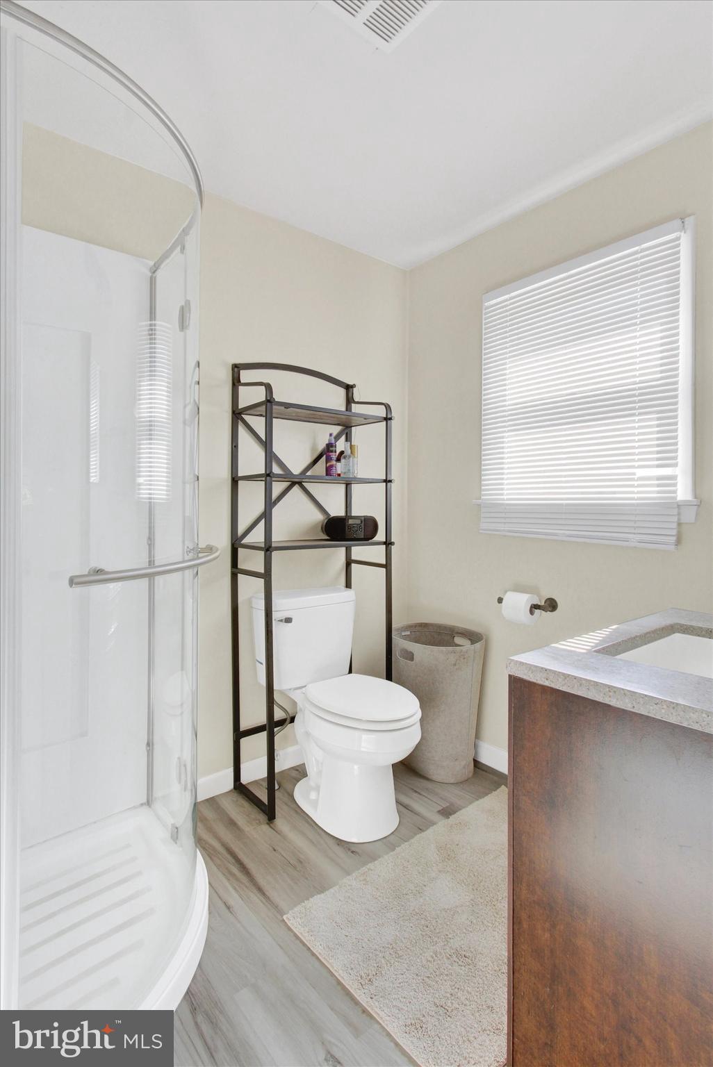 1365 Hanover Road Gettysburg, PA 17325 - Photo 16 of 26 a bathroom with a toilet sink a mirror and shower