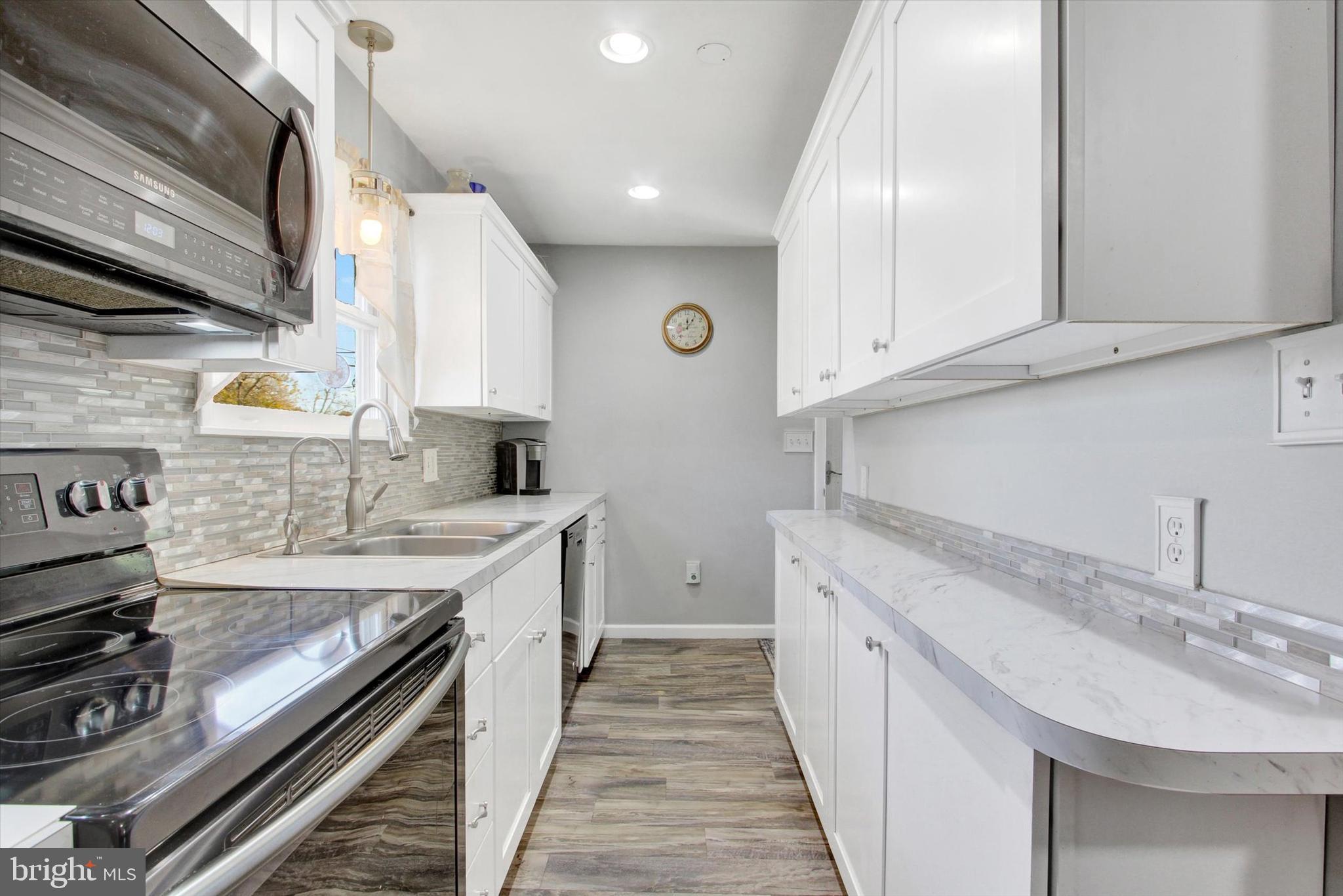 1365 Hanover Road Gettysburg, PA 17325 - Photo 10 of 26 a kitchen with a sink stove and cabinets