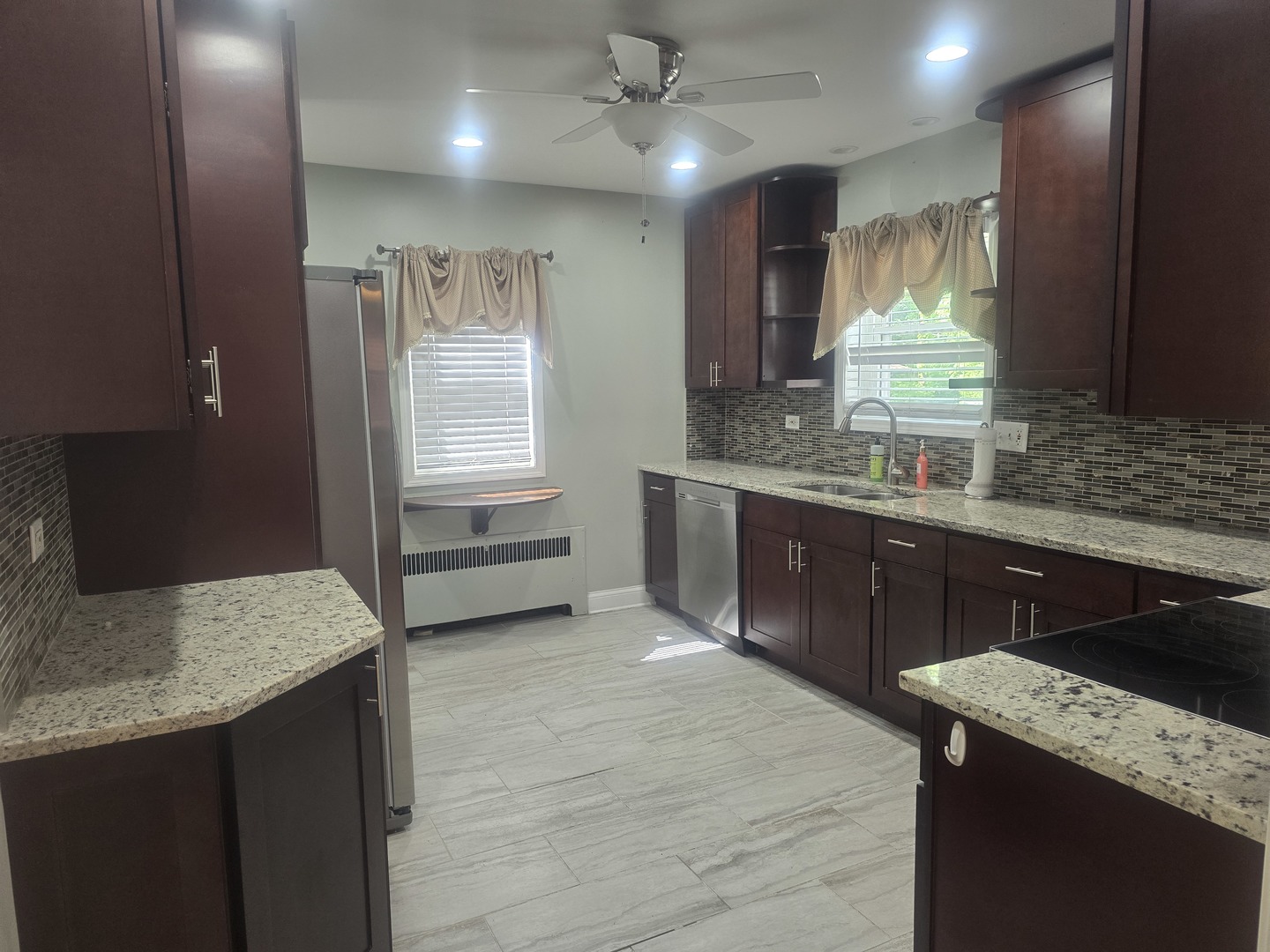 312 Nuttall Road Riverside, IL 60546 - Photo 5 of 35 a kitchen with kitchen island granite countertop a sink cabinets and wooden floor