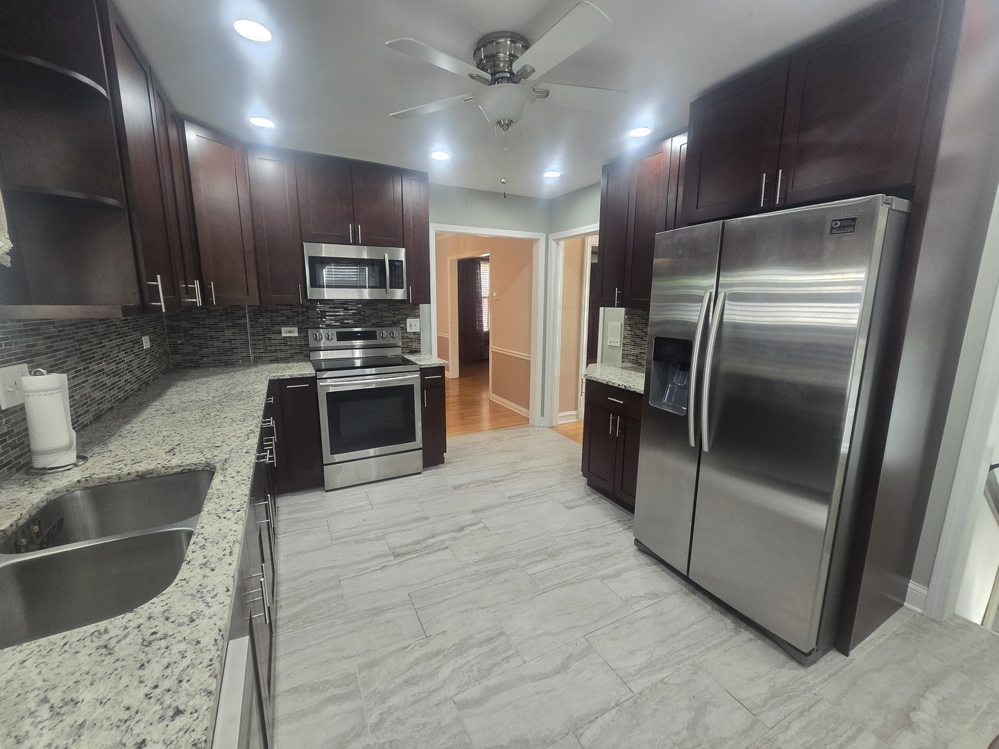 312 Nuttall Road Riverside, IL 60546 - Photo 6 of 35 a kitchen with stainless steel appliances granite countertop a refrigerator and a sink
