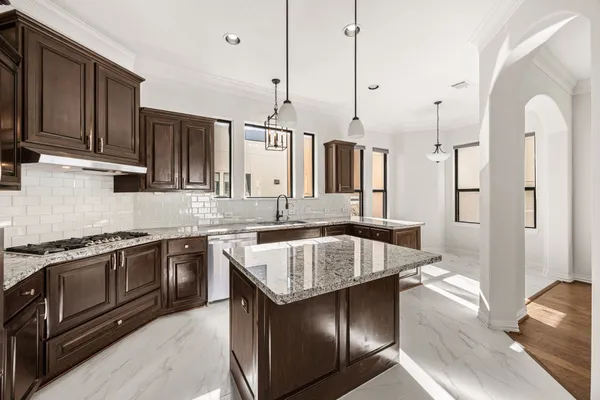 a kitchen with granite countertop stainless steel appliances and wooden cabinets