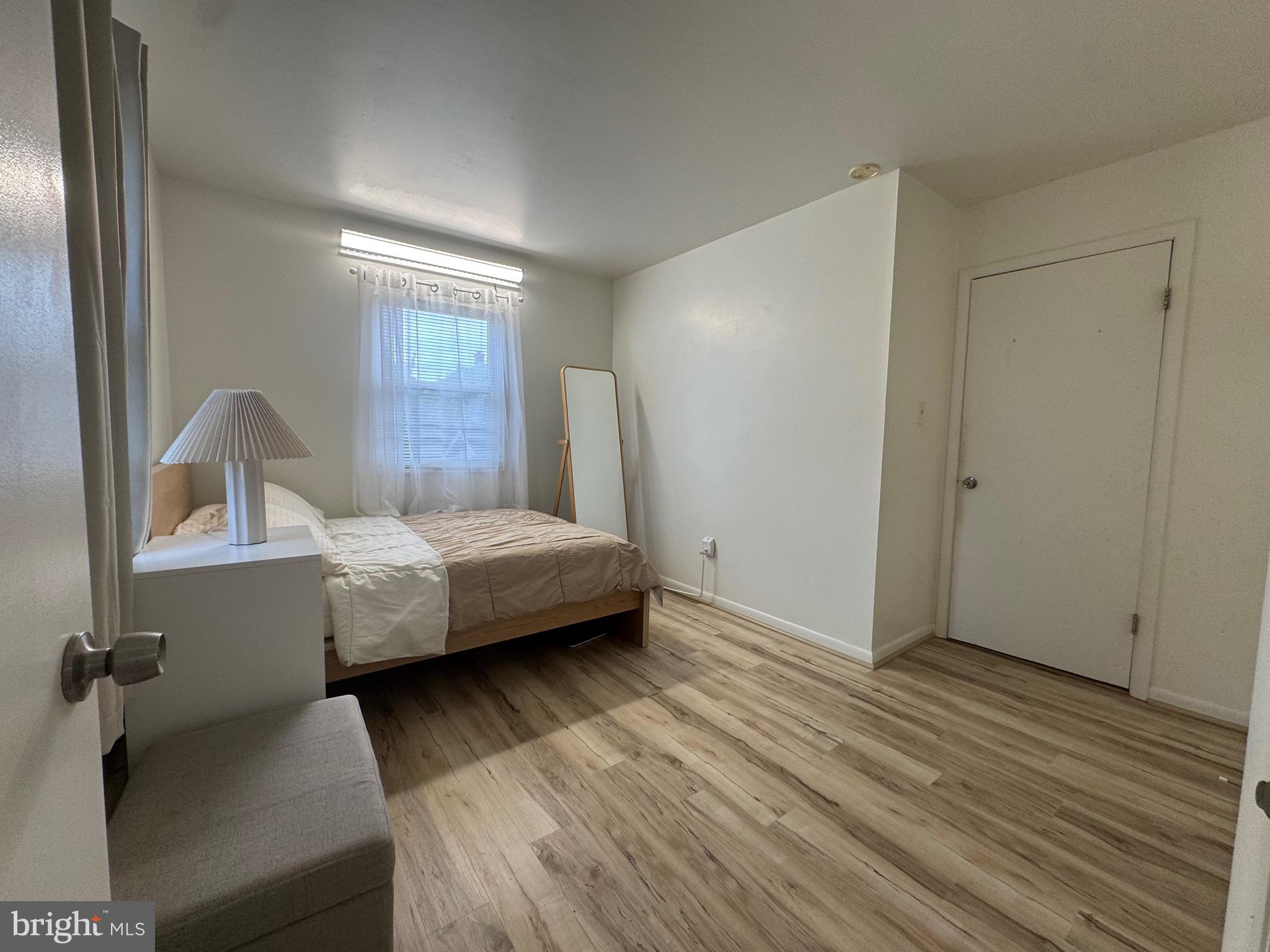 212 11th Street Laurel, MD 20707 - Photo 17 of 39 a bedroom with a bed and wooden floor