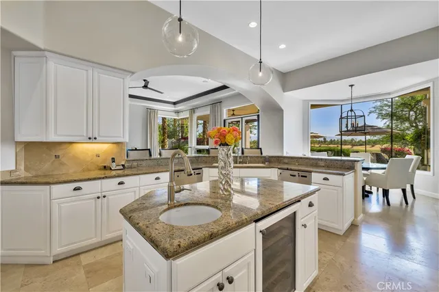 a kitchen with stainless steel appliances granite countertop a sink and cabinets