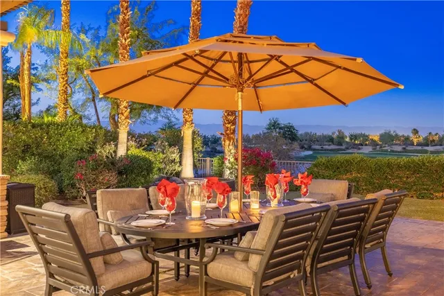 a view of an outdoor space with furniture and umbrella