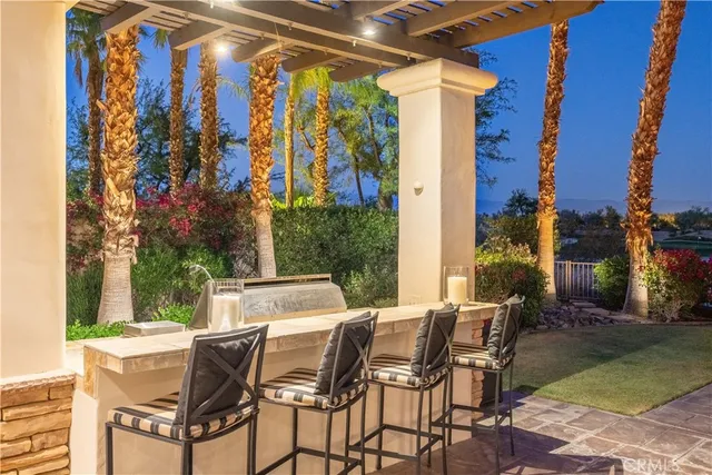 a view of a patio with a table and chairs and potted plants