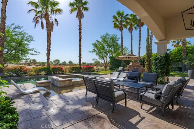 a view of swimming pool with outdoor seating and plants