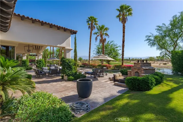 a view of a chair and tables in the patio in front of a house