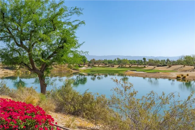 a view of lake with a house in background