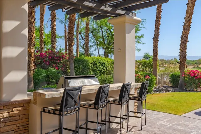 a view of an outdoor dining space with a table and chairs
