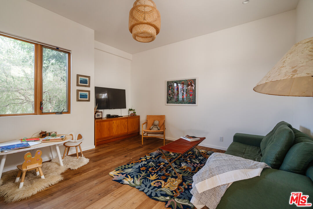 2002 Tuna Canyon Road Topanga, CA 90290 - Photo 23 of 70 a living room with furniture a flat screen tv and a large window