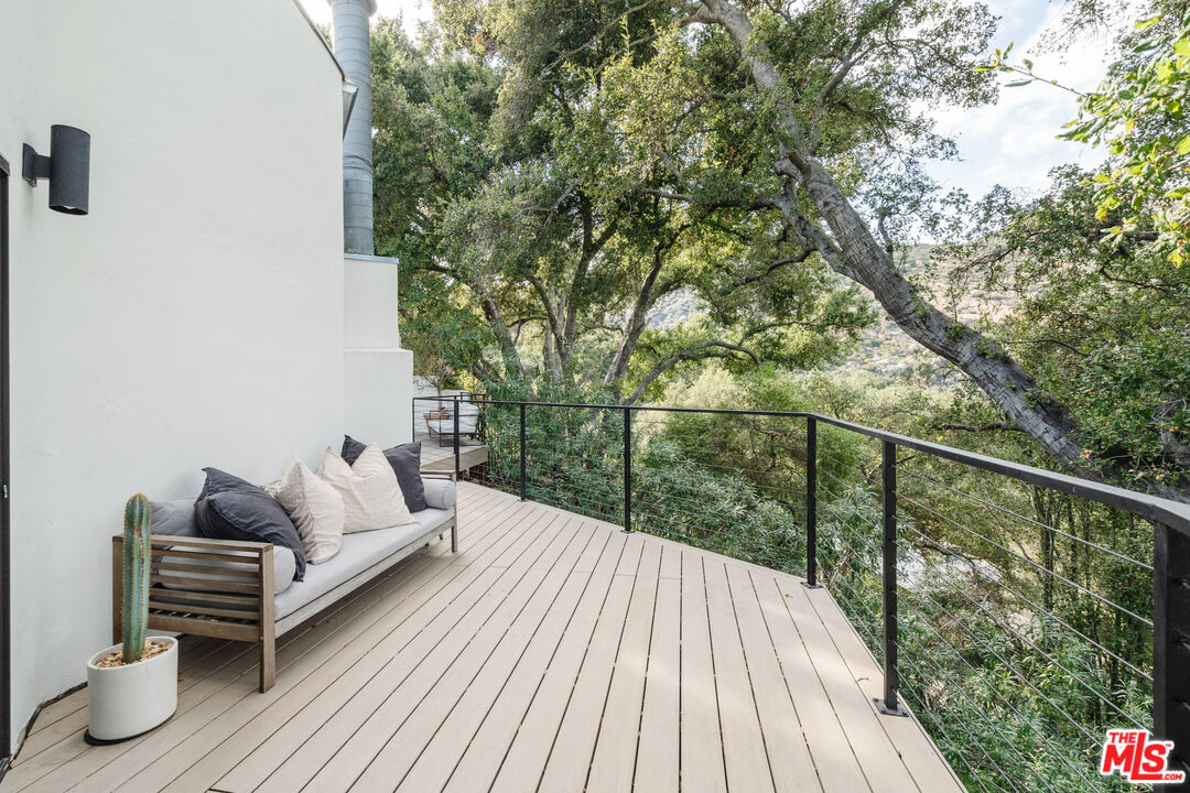 2002 Tuna Canyon Road Topanga, CA 90290 - Photo 49 of 70 a balcony with wooden floor and outdoor seating