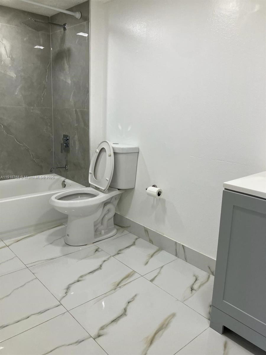 4025 West McNab Road, Unit E105 Pompano Beach, FL 33069 - Photo 8 of 9 a bathroom with a toilet sink and shower