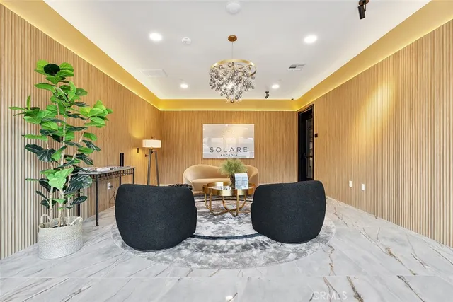 a living room with couches and a potted plant