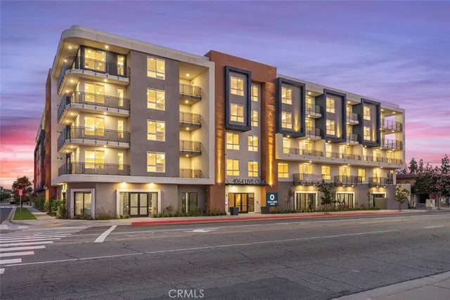 a city street lined with buildings and trees