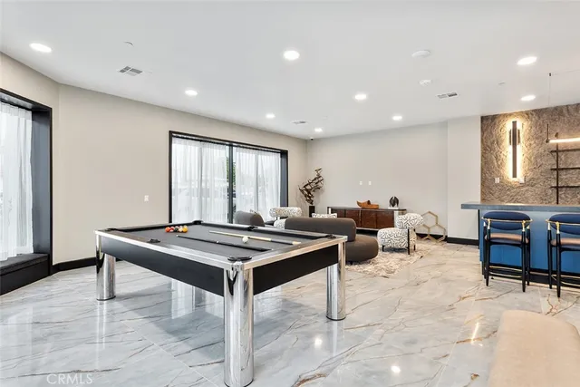 a room with furniture pool table and windows