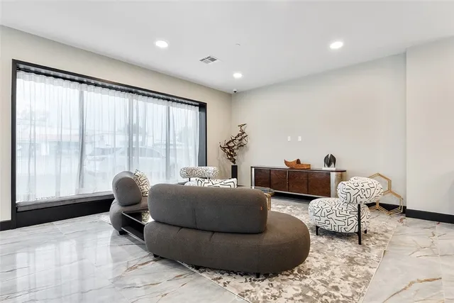 a living room with furniture and large windows