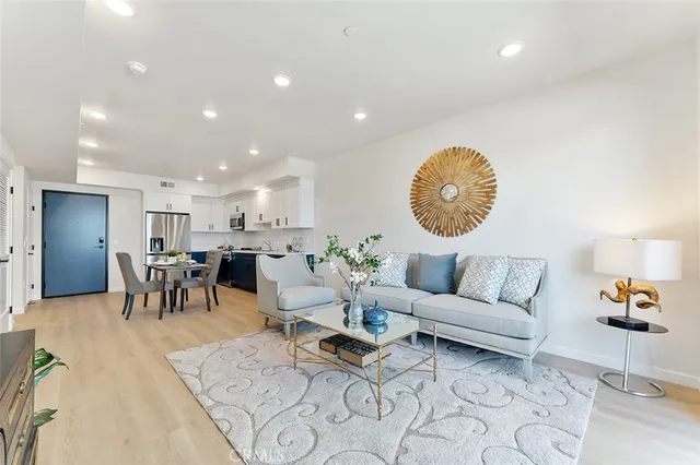 a living room with furniture a clock and a table