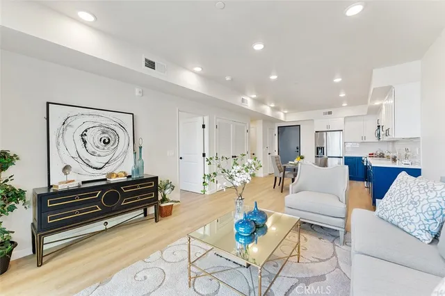 a living room with furniture and kitchen view
