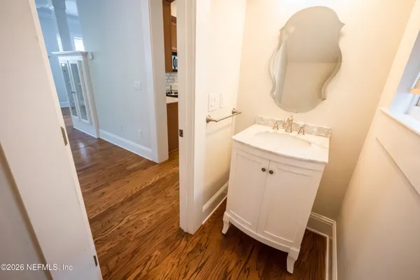a bathroom with a sink a toilet and mirror