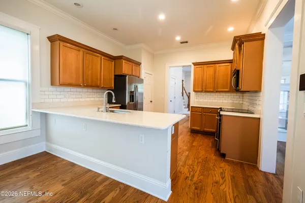 a kitchen with stainless steel appliances a refrigerator and a stove