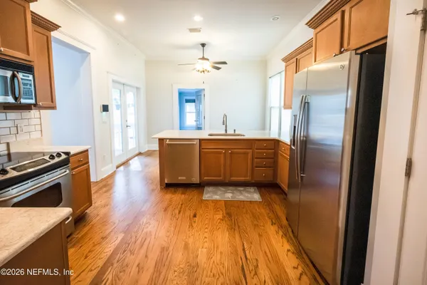a kitchen with stainless steel appliances granite countertop a stove a sink and a microwave