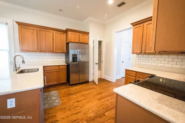 a kitchen with a sink a stove and cabinets