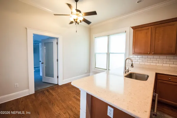 a large kitchen with kitchen island a large counter space a sink appliances and cabinets