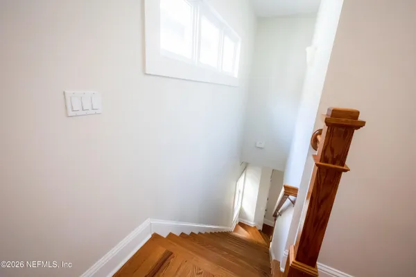 an empty room with closet and windows