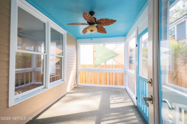 a view of a house with a door and wooden fence