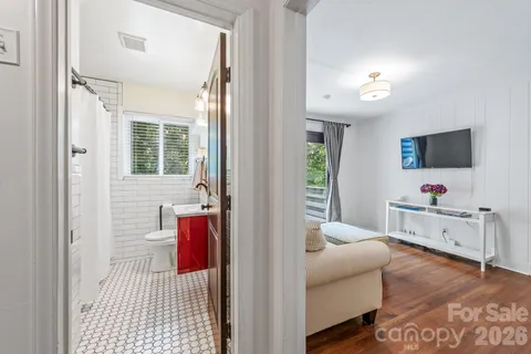 a bedroom with furniture and a flat screen tv