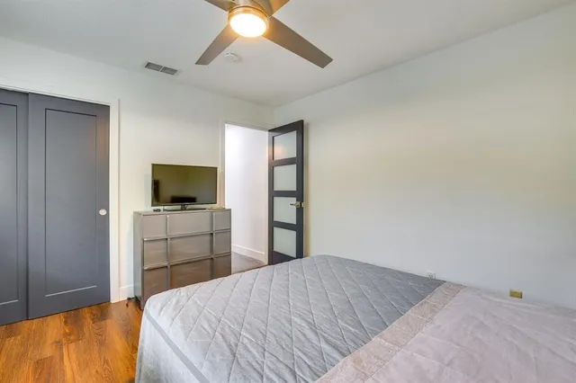 a bedroom with a bed and a flat screen tv