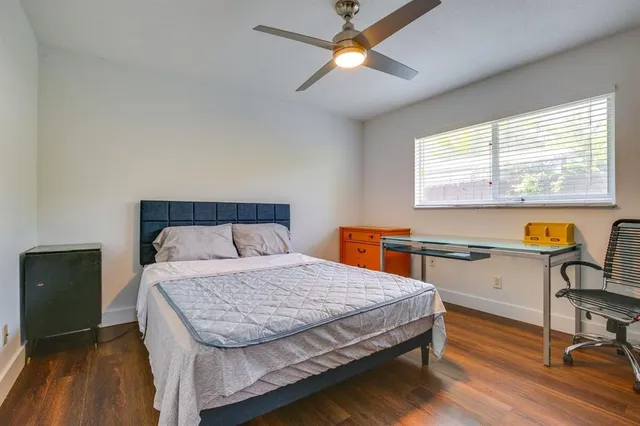 a bedroom with a bed and a table with chair