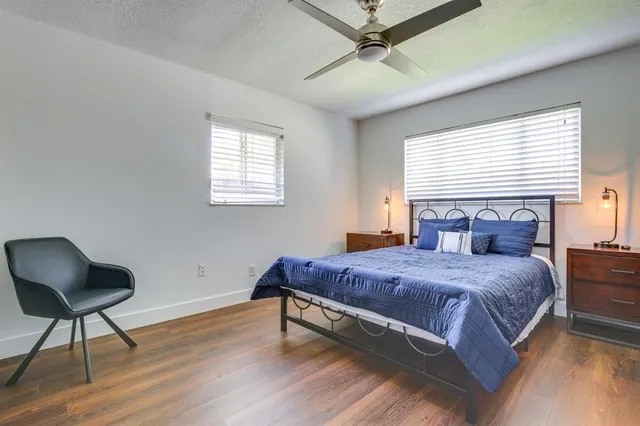 a bedroom with a bed and a chair