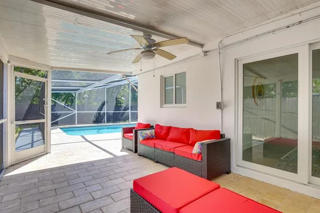 a living room with furniture and a glass door