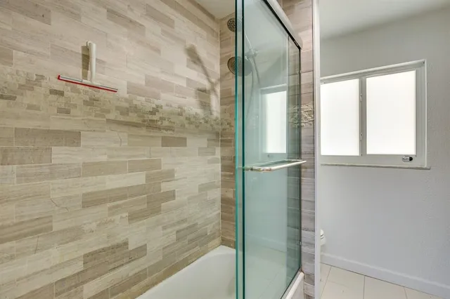 a bathroom with a glass shower door