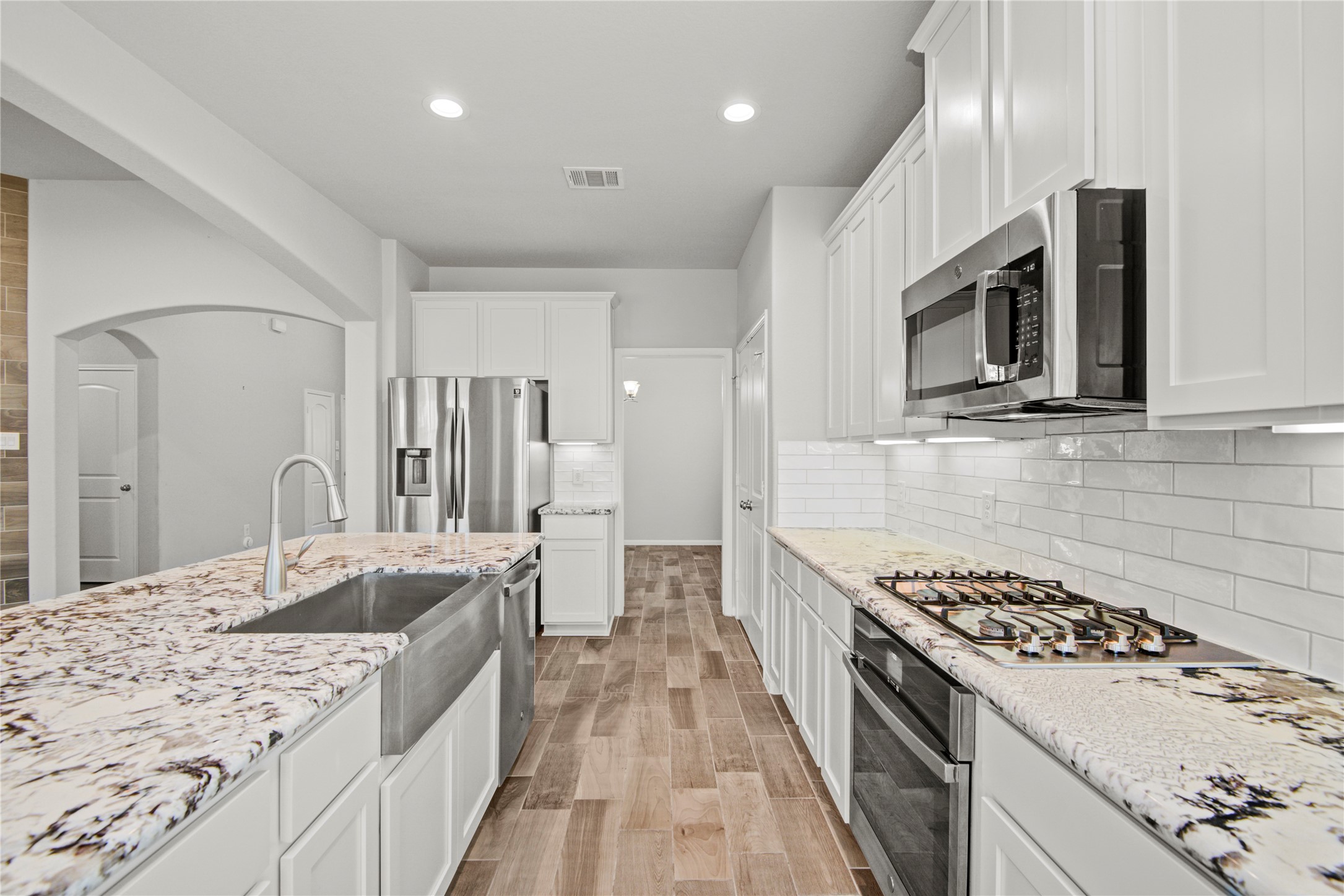 1314 Orchard Ridge Lane Tomball, TX 77375 - Photo 14 of 35 A large center island provides additional prep space, seating potential, and a natural gathering point.