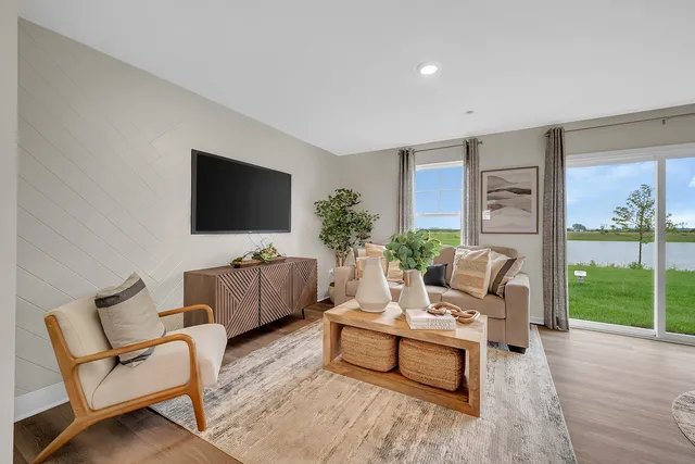 a living room with furniture a flat screen tv and a fireplace