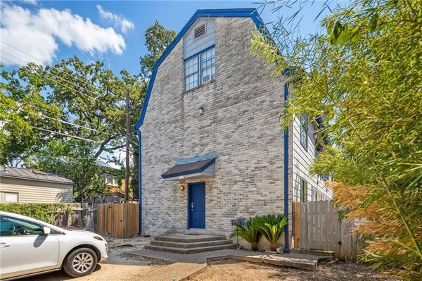a front view of a house with parking area